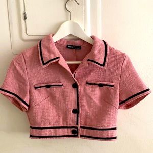 Beautiful Crop pink blouse with black stitching and buttons.